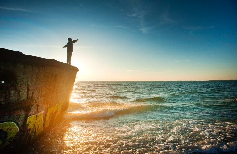 silhouette-of-person-on-cliff-beside-body-of-water-during-1060489 (1)